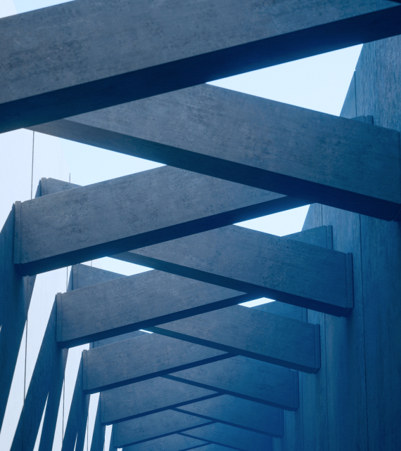 Upwards view of a corridor with intersecting diagonal concrete beams