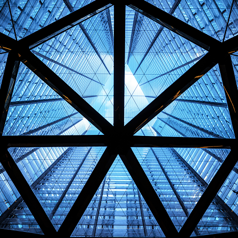Modern glass building ceiling framed by a geometric steel structure