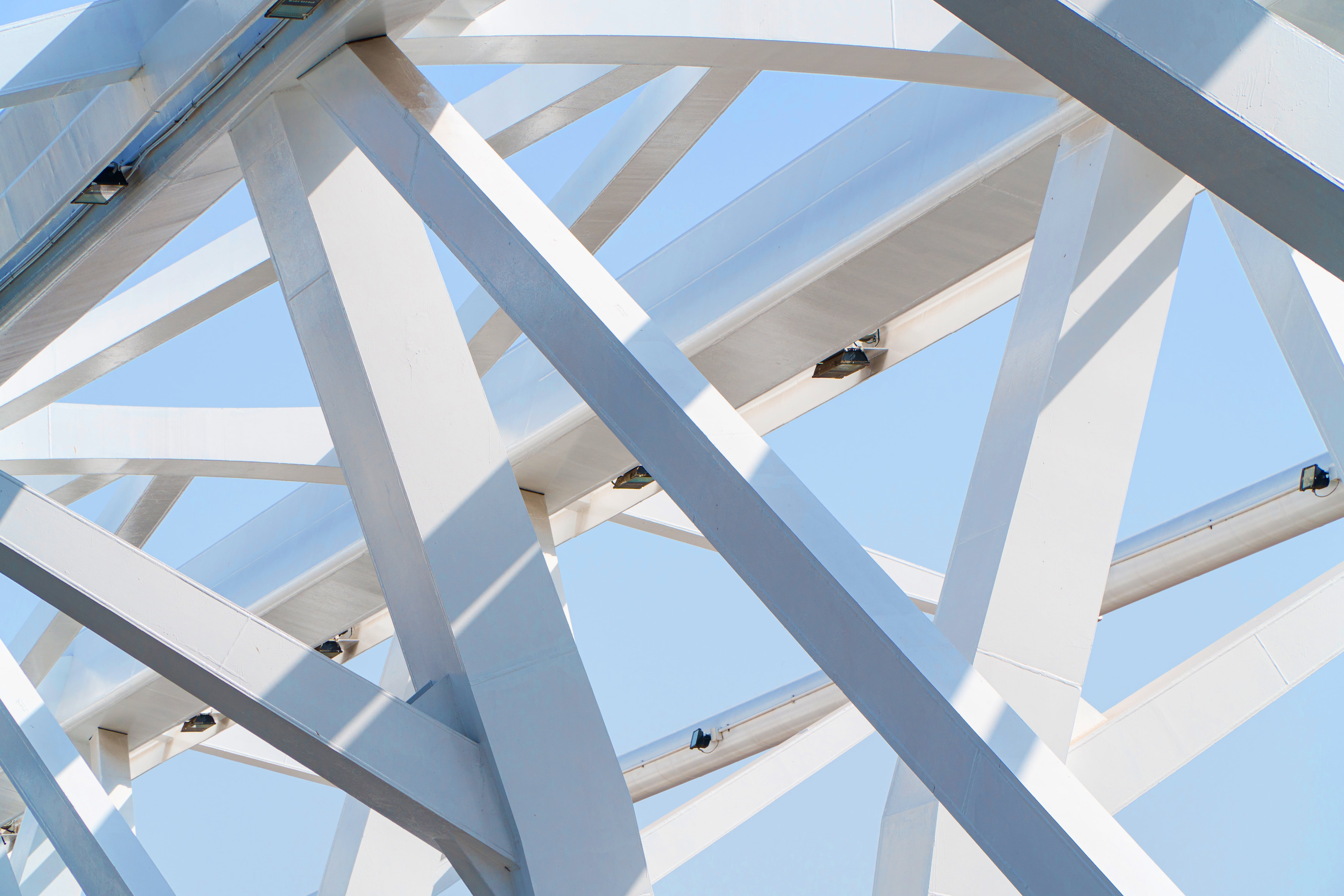 White steel beams against a blue sky backdrop